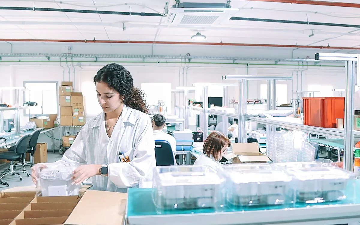 Operator checking finished units on the assembly line