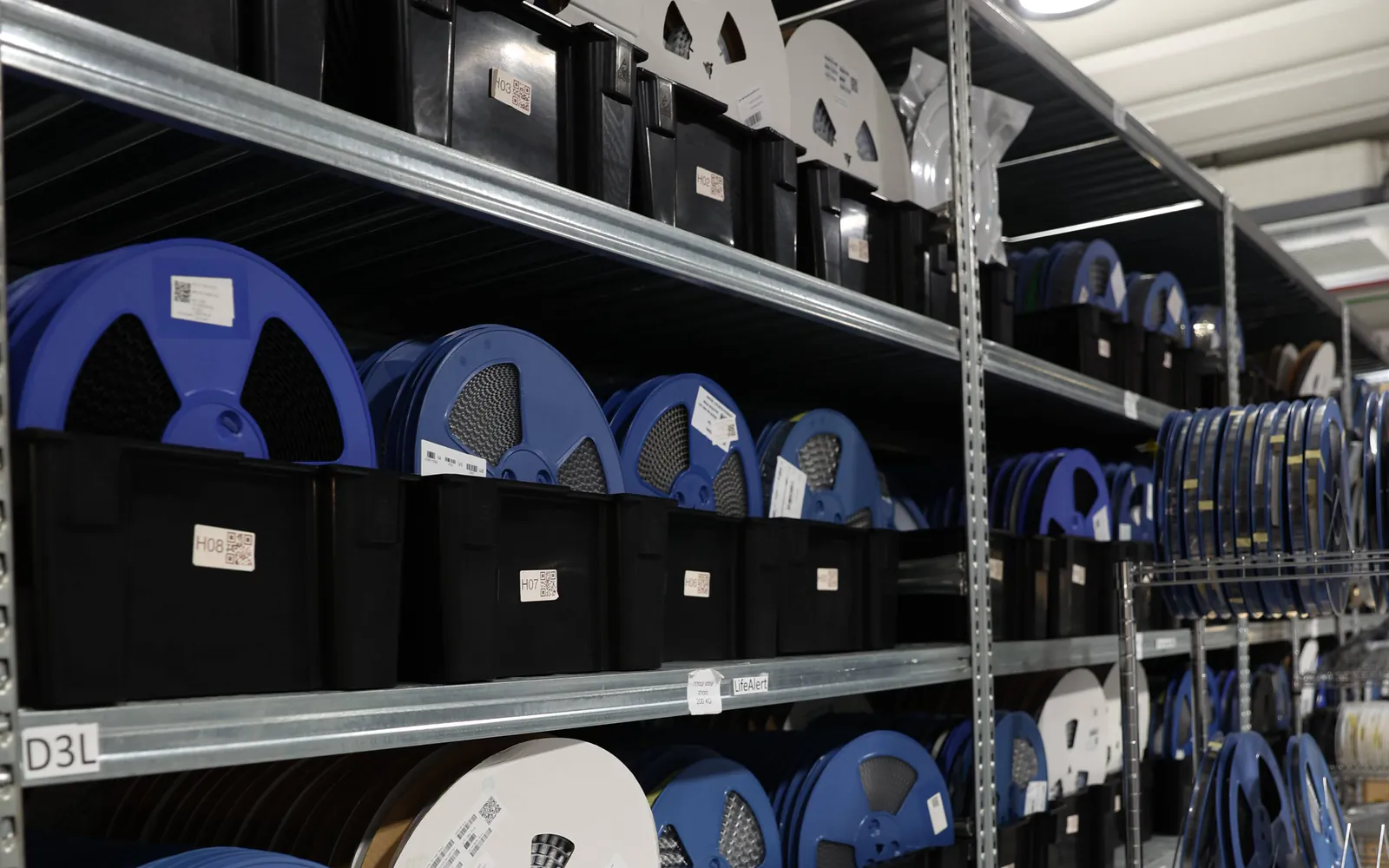 Labelled component reels in organised storage